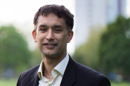 Dave Raval standing in front of a new block of flats