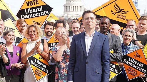 Rob Blackie pictured with Liberal Democrat activists holding signs